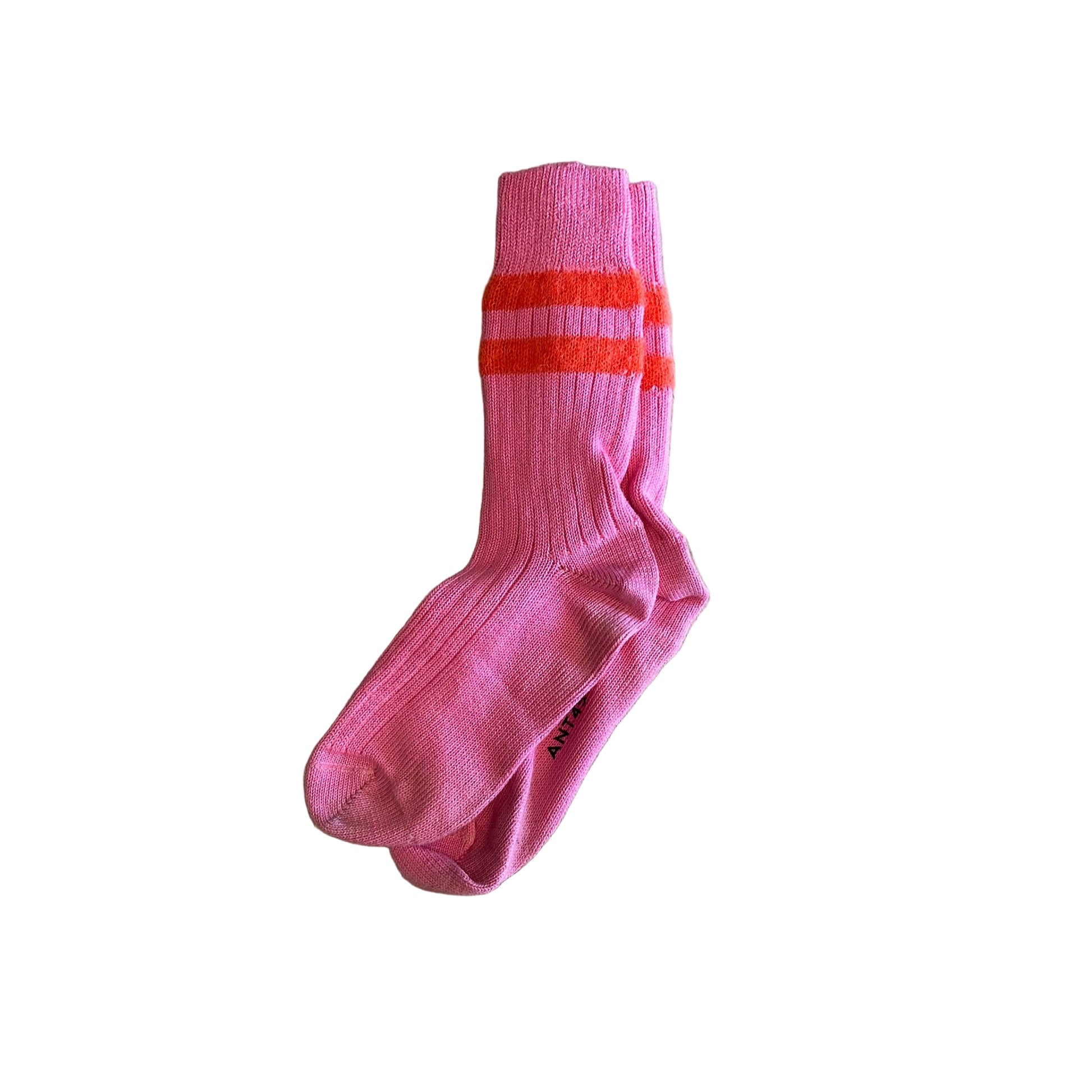 Pink sock with two red stripes on a wooden floor
