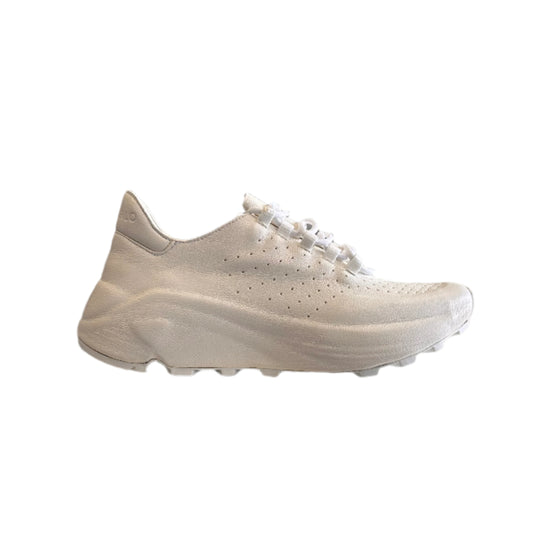 White sneakers displayed on a rack with a blurred background