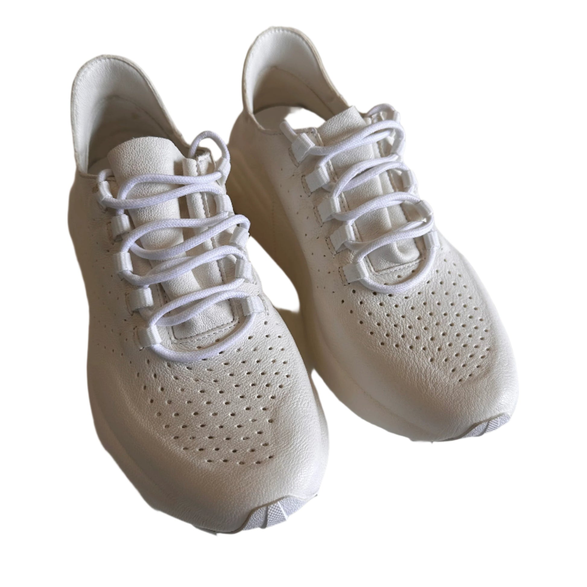 White sneakers with laces on a light-colored surface