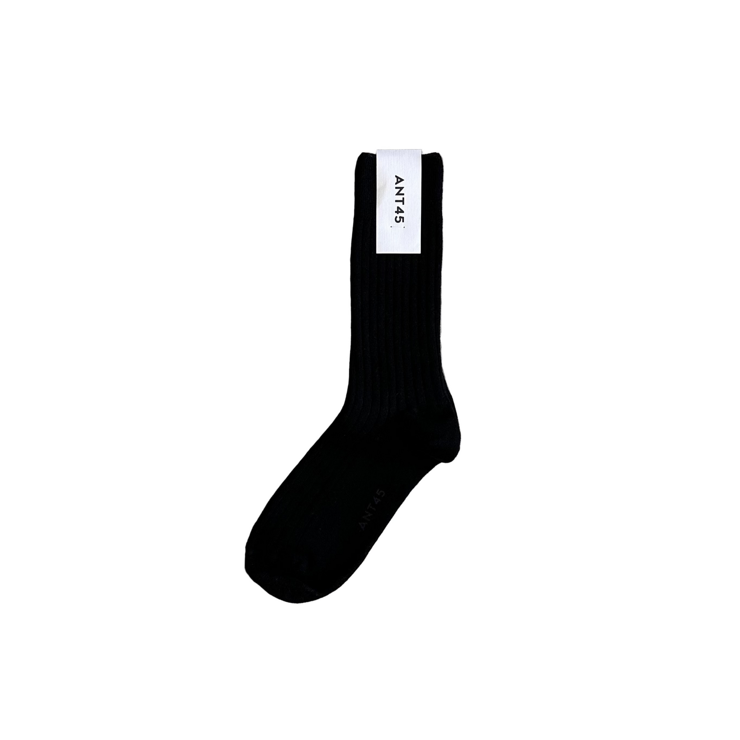 Black sock with a brand label on a wooden floor
